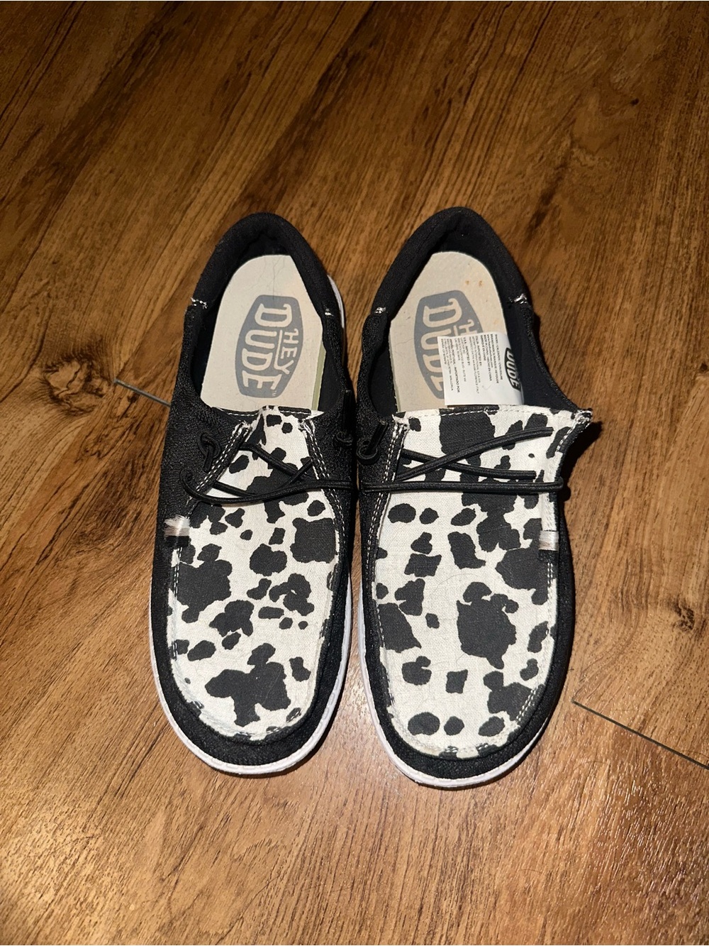 Hey Dude Women's Black and White Cow Print Slip-On Shoes